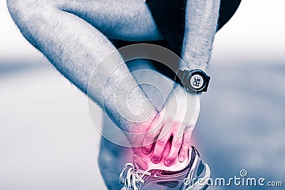 Leg ankle pain, man holding sore and painful foot Stock Photo