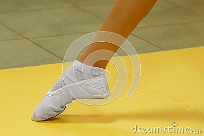 Leg of a girl in ballerinas. Ballet or leg stretch. shoes for yoga, ballet Stock Photo