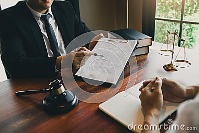 Legal advisor is explaining the offense under the law in the book at office Stock Photo