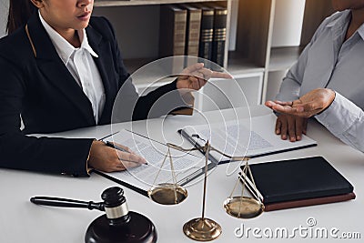 Legal advisor is explaining the offense under the law in the book at office Stock Photo