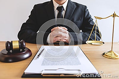 Legal law, advice and justice concept, male lawyer or notary working on a documents and report of the important case and wooden g Stock Photo