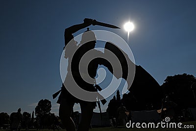 Legionary with gladius sword, helmet and shield combats in silhouette during Tempora in Aquileia, ancient Roman re-enactment Editorial Stock Photo