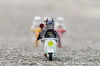 lego batman riding scooter with stormtrooper riding bicycle on patrol Editorial Stock Photo