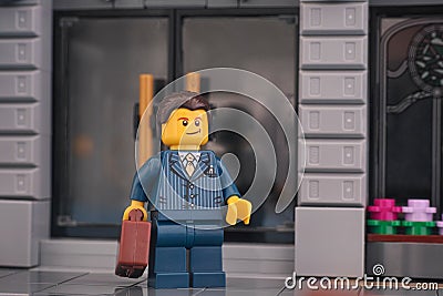 Lego businessman standing on the street in front of a bank Editorial Stock Photo