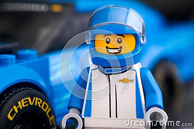 Lego Chevrolet Camaro ZL1 driver minifigure by LEGO Speed Champions against his car Editorial Stock Photo