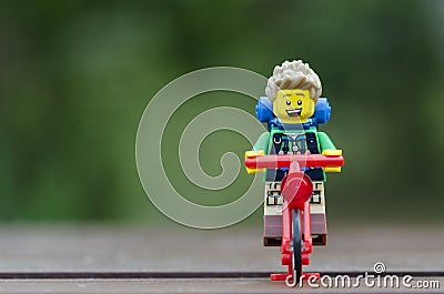 Lego hiker riding bicycle. Editorial Stock Photo