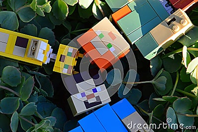 LEGO Minecraft figures of Alex, Steve and ocelot cat mob relaxing on decorative succulent plant foliage, viewed from above Editorial Stock Photo