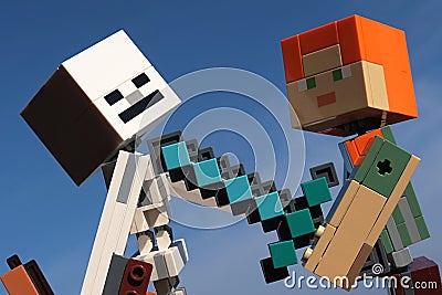 Lego Minecraft large action figure of Alex with diamond sword stabbing skeleton archer. Editorial Stock Photo