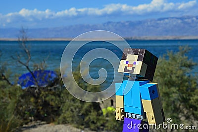 LEGO Minecraft large figure of Steve sunbathing in afternoon sunshine on Nin sandy beach, northern Dalmatia, Croatia. Editorial Stock Photo