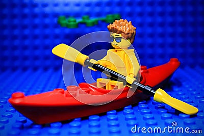 Lego mini-figure rowing boat across the river Editorial Stock Photo