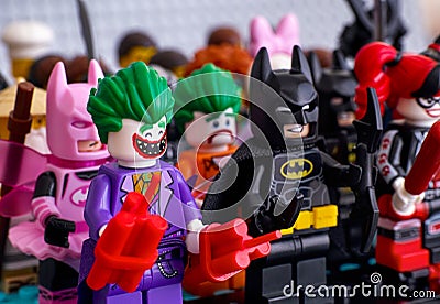 Lego minifigures standing in rows. In first row - The Joker, Bat Editorial Stock Photo