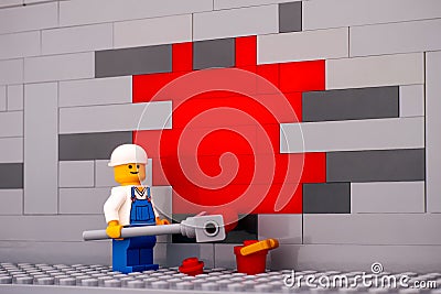 Lego painter minifigure painting a wall red Editorial Stock Photo