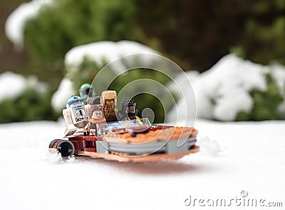 lego star wars minifigures droid r2d2 c3po lando and han solo riding on speeder during winter Editorial Stock Photo