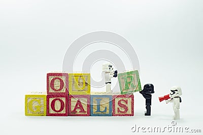 Lego storm trooper assembling word our goals using alphabets blocks. Editorial Stock Photo