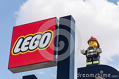 Legoland Dubai Theme Park Resort for children Lego Logo sign with a blue sky background and fireman statue. Luxury travel resort Editorial Stock Photo