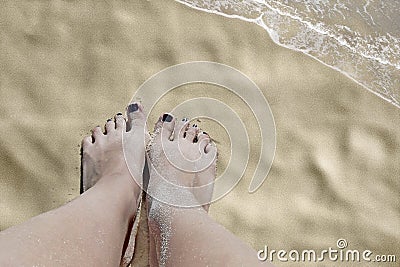 Legs on beach sand Stock Photo