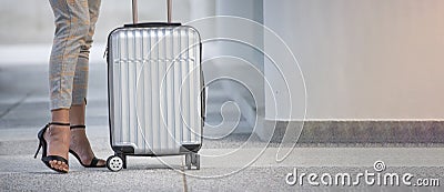Legs of a businesswoman Dragging suitcase luggage bag, walking to passenger boarding in Airport. Woman travel to work. Stock Photo