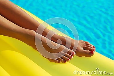  Legs close up. Creative gel polish red Stock Photo