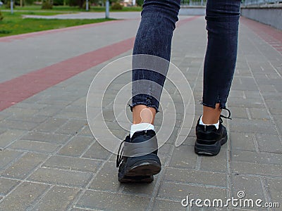 Legs close-up teenager walking down the Stock Photo