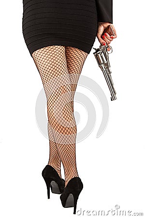 Legs of dangerous woman with handgun and black shoes Stock Photo