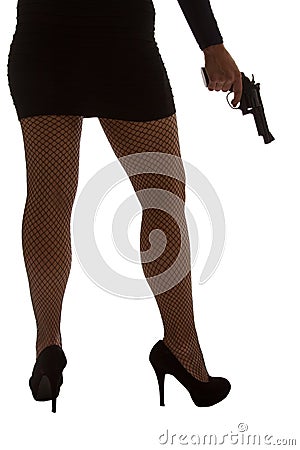 Legs of dangerous woman with handgun and black shoes silhouette Stock Photo