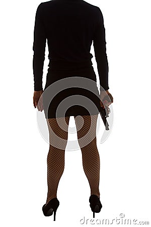 Legs of dangerous woman with handgun and black shoes Stock Photo