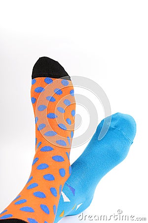 Legs with different a pair of mismatched socks on white background. World Down syndrome day background. Stock Photo