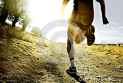 Legs and feet extreme cross country man running training at countryside sunset Stock Photo