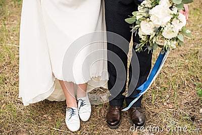 Legs and feet of married couple in stylish shoes Stock Photo