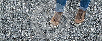 Legs of a girl in brown sneakers Stock Photo