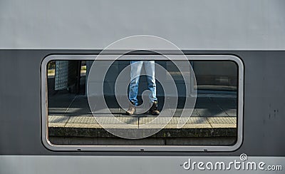 Legs of a man in jean and sneakers Stock Photo