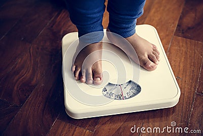 Legs of man on weight scale Stock Photo