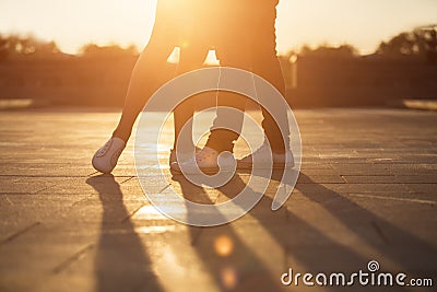 Legs of man and woman. Loving couple embracing at sunset Stock Photo