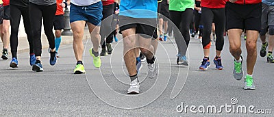 legs of many runners at footrace in the city Stock Photo