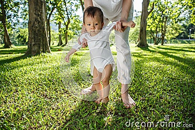 Legs of mother and baby. First steps Stock Photo