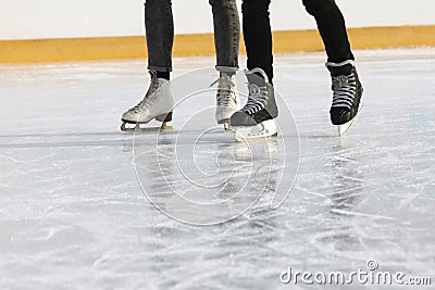 Legs people together skating on the ice rink Stock Photo