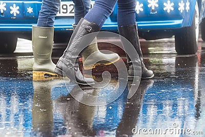 Legs of people walking in rain with wellies on Editorial Stock Photo