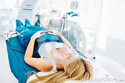 Legs pressotherapy machine on woman patient in hospital bed Stock Photo