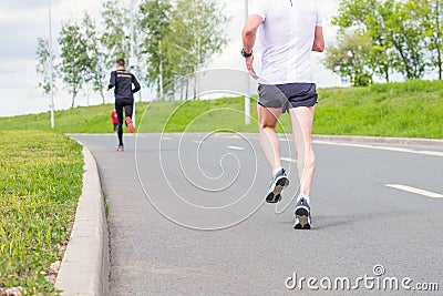 legs of a running athlete for a long distance on asphalt Editorial Stock Photo