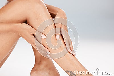 Legs, skin care and body of a woman in studio for hair removal, epilation or waxing for smooth shine. Natural model Stock Photo