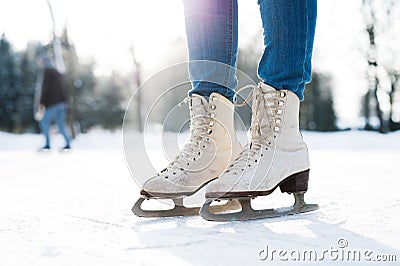 Legs of unrecognizable woman ice skating outdoors, close up. Stock Photo