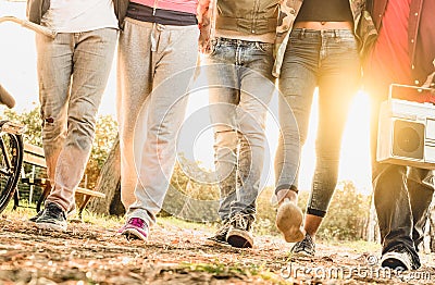 Legs view of friends walking in city bike park with backlight Stock Photo