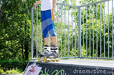 Legs of a young roller skater on a cement ramp Stock Photo