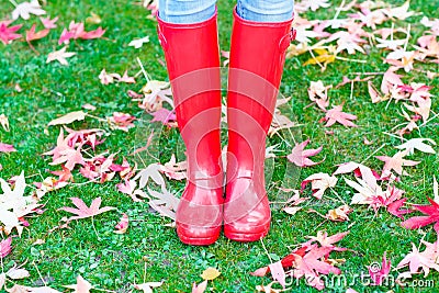 Legs of young woman in red rainboots. Stock Photo