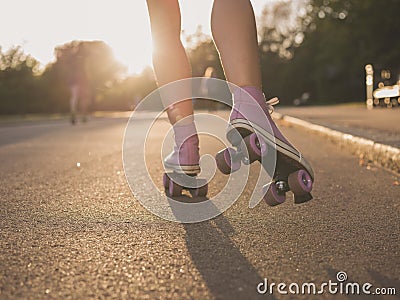 Legs of young woman roller skating in park Stock Photo