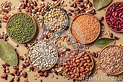 Legumes assortment, shot from above on a brown background. Lentils, soybeans, chickpeas, red kidney beans Stock Photo