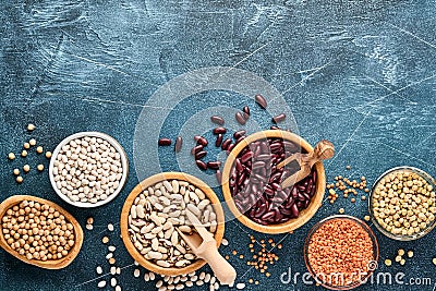 Legumes, lentils, chickpea, beans assortment, tasty appetizing ingredients spices grocery for cooking healthy kitchen on black tab Stock Photo