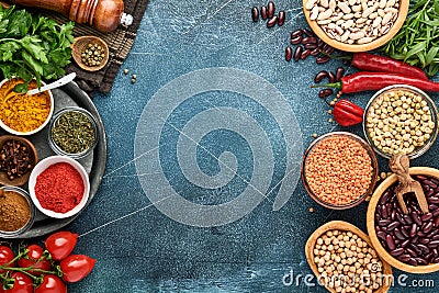 Legumes, lentils, chickpea, beans assortment, tasty appetizing ingredients spices grocery for cooking healthy kitchen on black tab Stock Photo