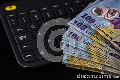 Lei banknotes on keyboard. Selective focus on stack of LEI romanian money Stock Photo