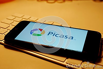 Leipzig, Germany - February 10, 2021: Closeup of smartphone screen with logo lettering of Picasa on computer keyboard Editorial Stock Photo